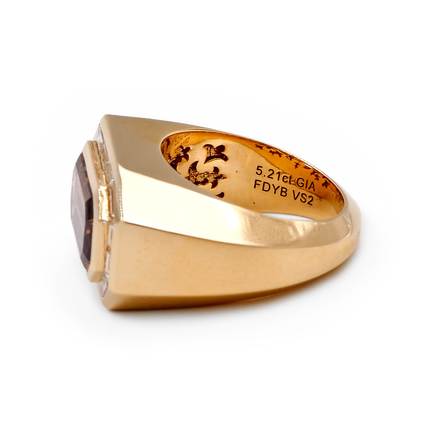 Gold ring with engraved text on a white background