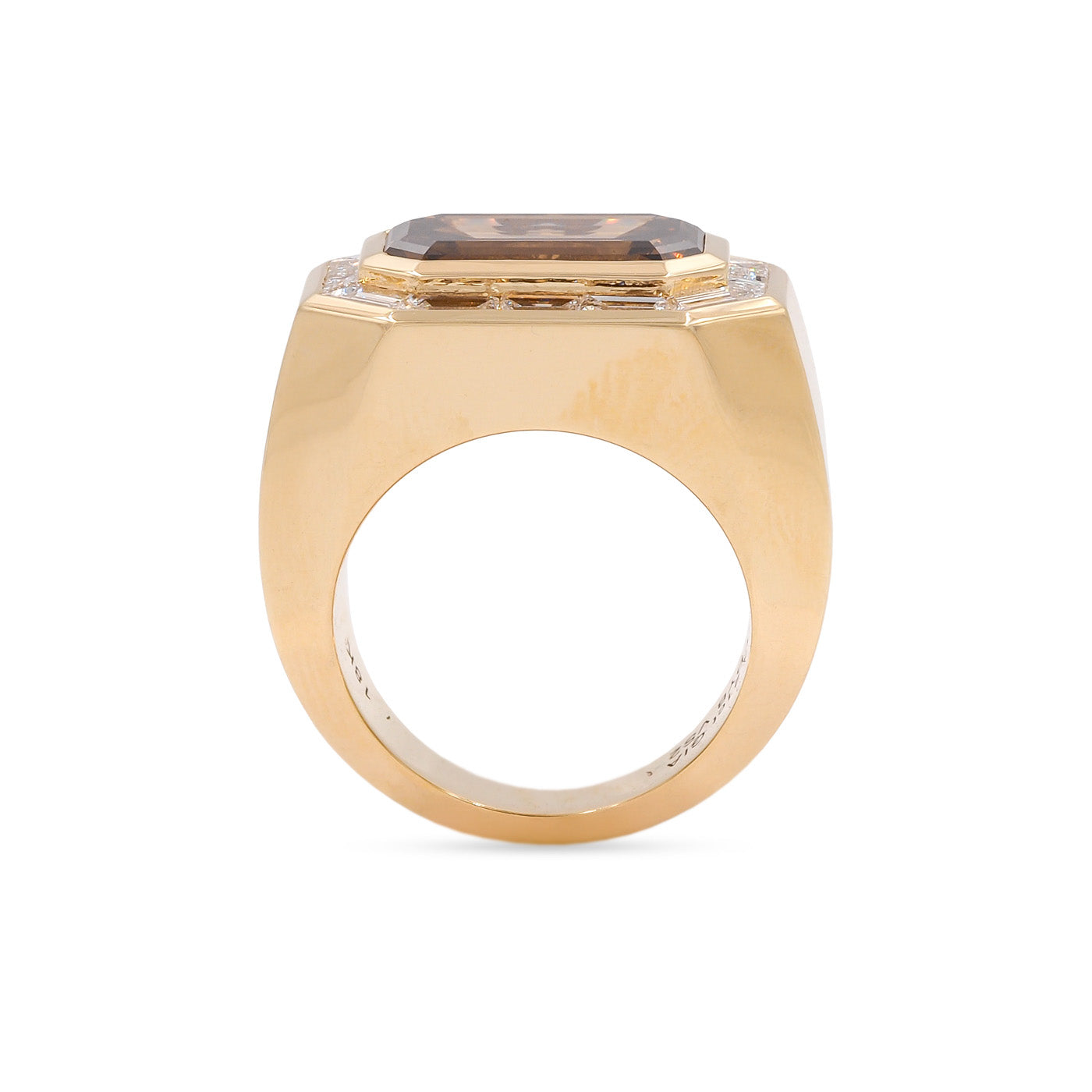 Gold ring with a central gemstone on a white background