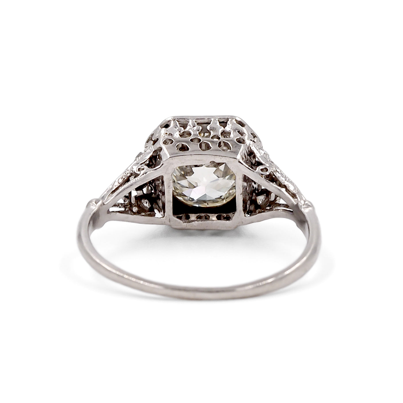 Diamond ring with intricate setting on a white background