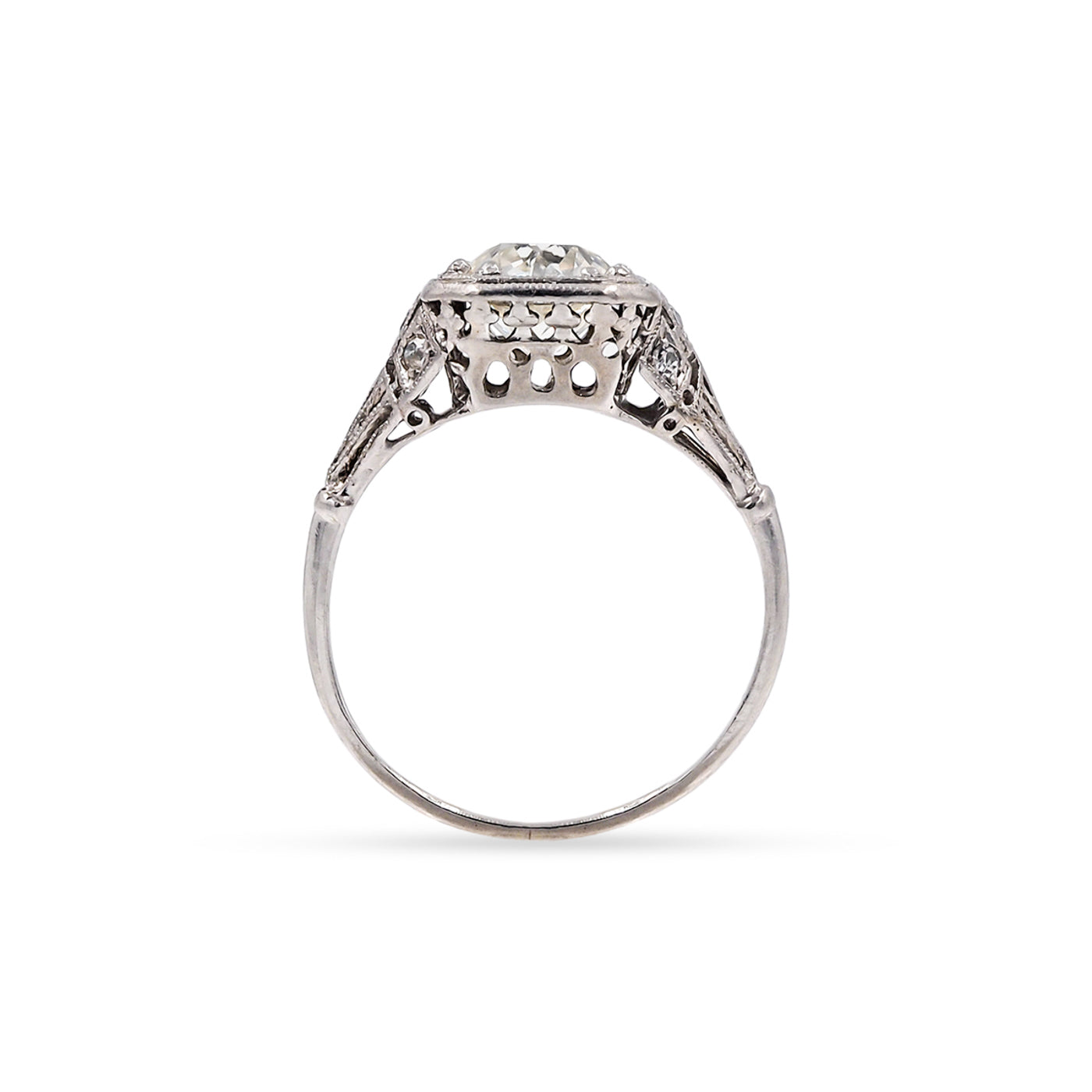 Silver ring with intricate solitaire design on a white background